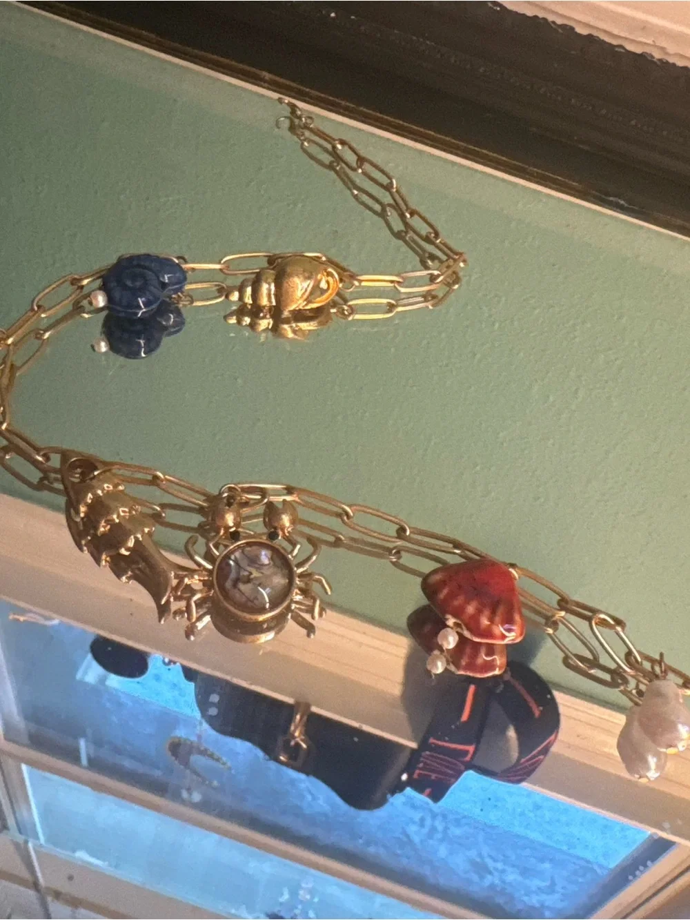 Anthropologie Gold-Tone Charm Necklace with Blue, Red and Pearl Accents